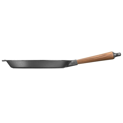 Professional grade cast iron frying pan with walnut handle, designed for superior heat retention and cooking performance in c