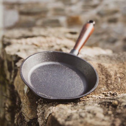Stylish and durable cast iron frying pan with walnut handle, perfect for everyday cooking and heat retention.