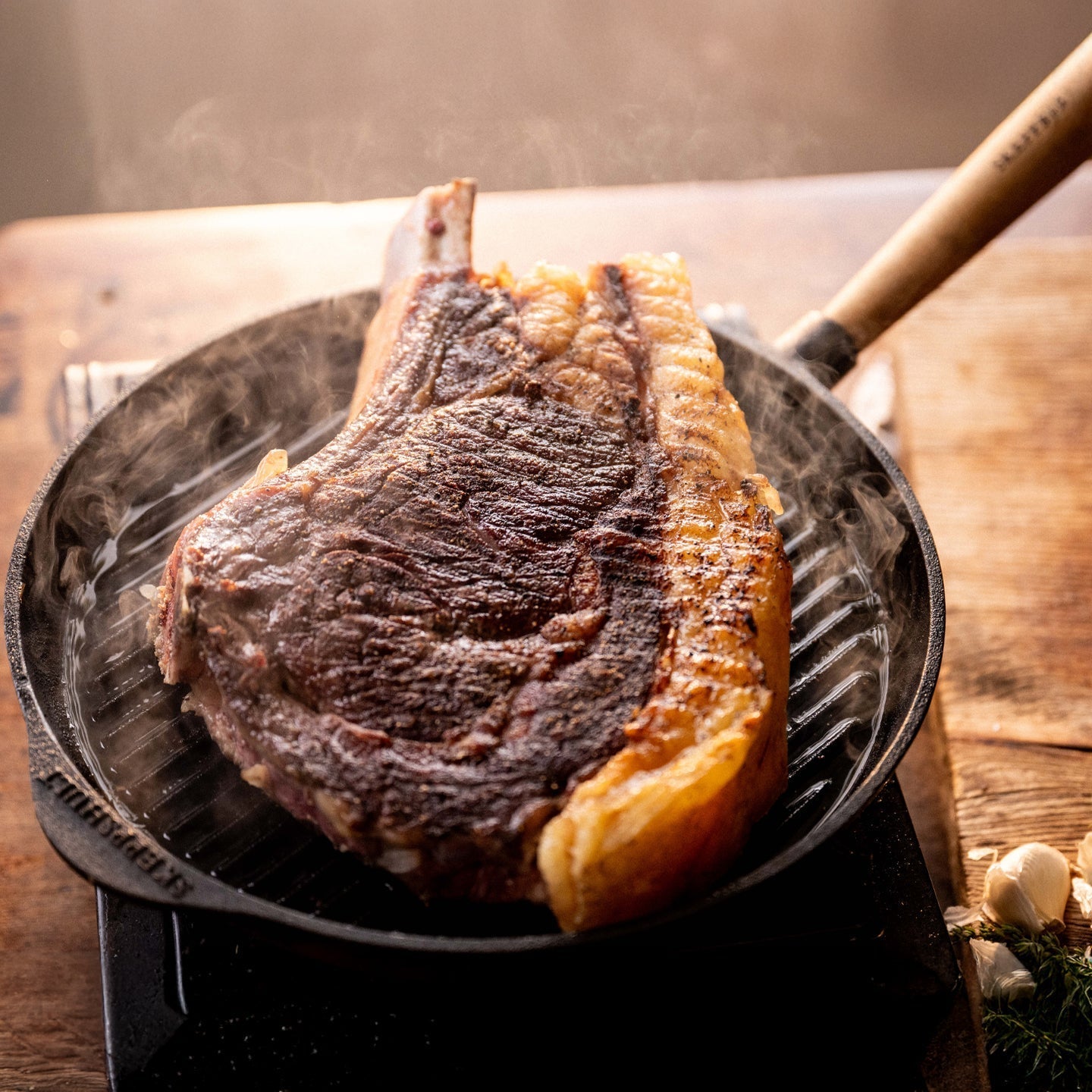 Skeppshult grill pan with walnut handle, made from heavy-duty cast iron for even heat distribution